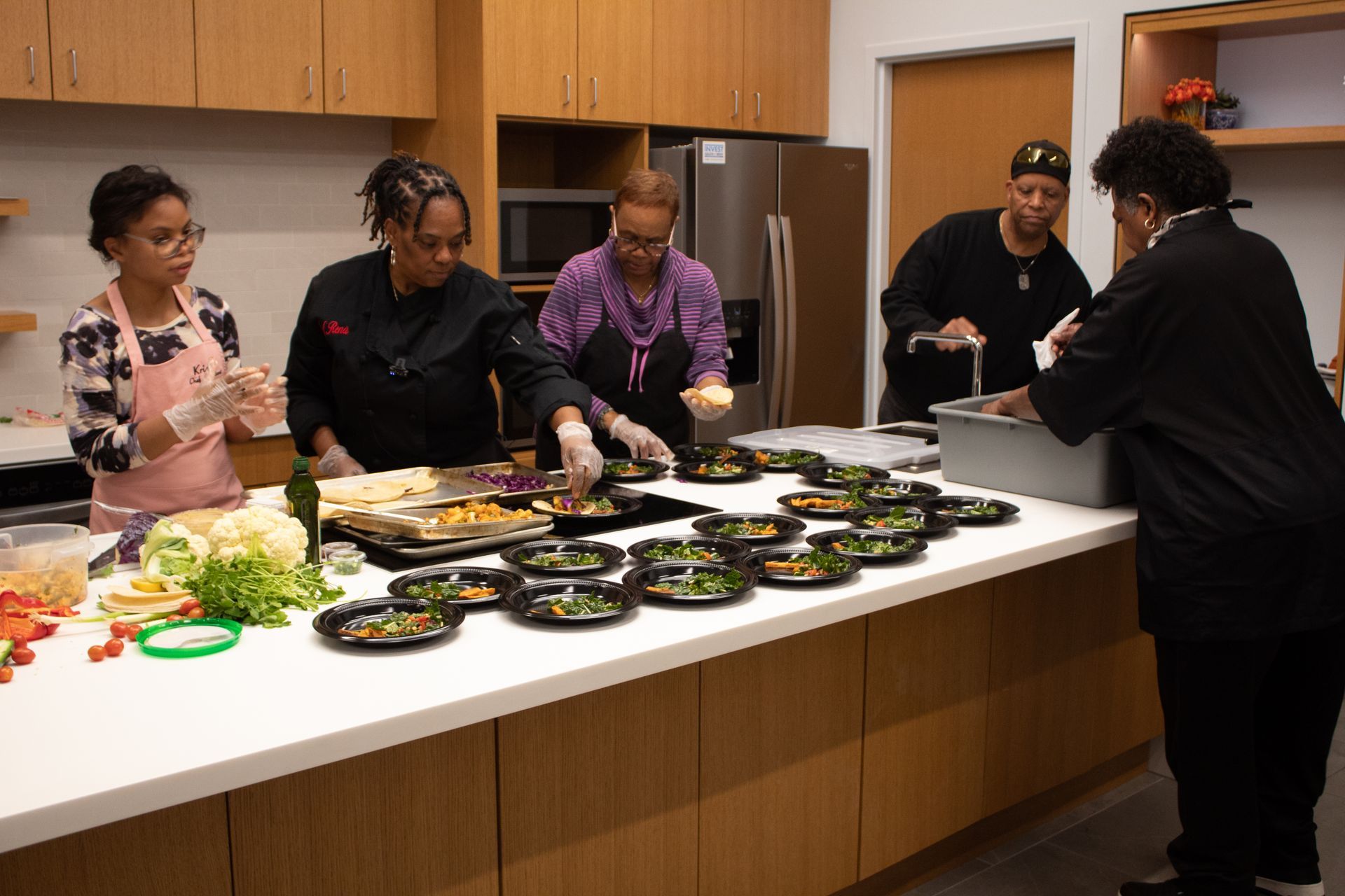 A group of people are walking in front of a varsity theater