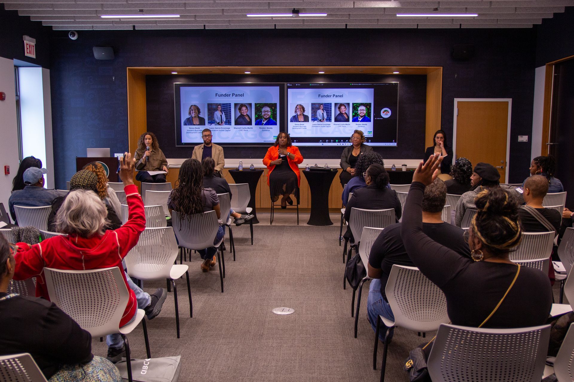 A group of people are walking in front of a varsity theater
