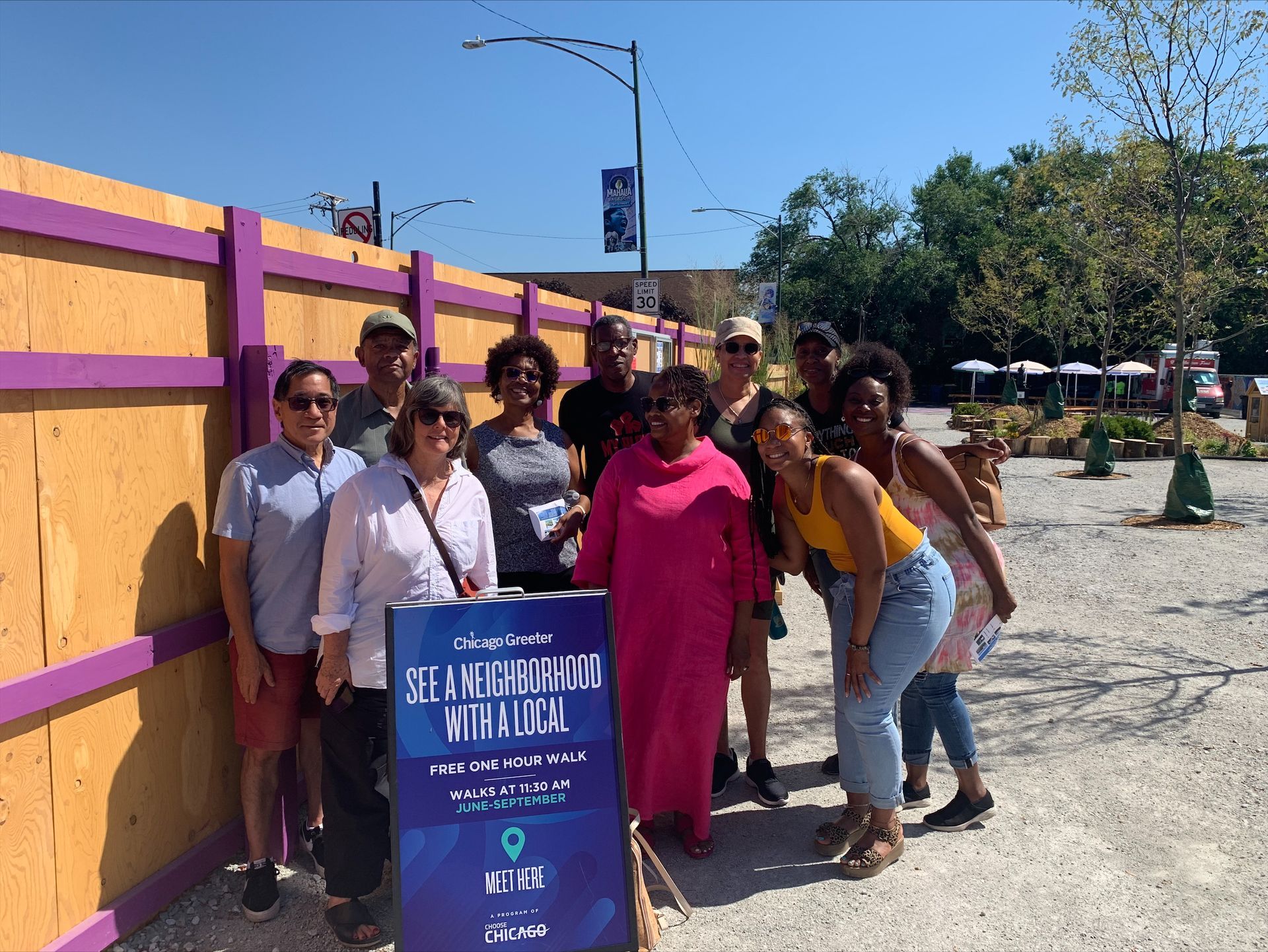 A woman is sitting at a bar holding two drinks.