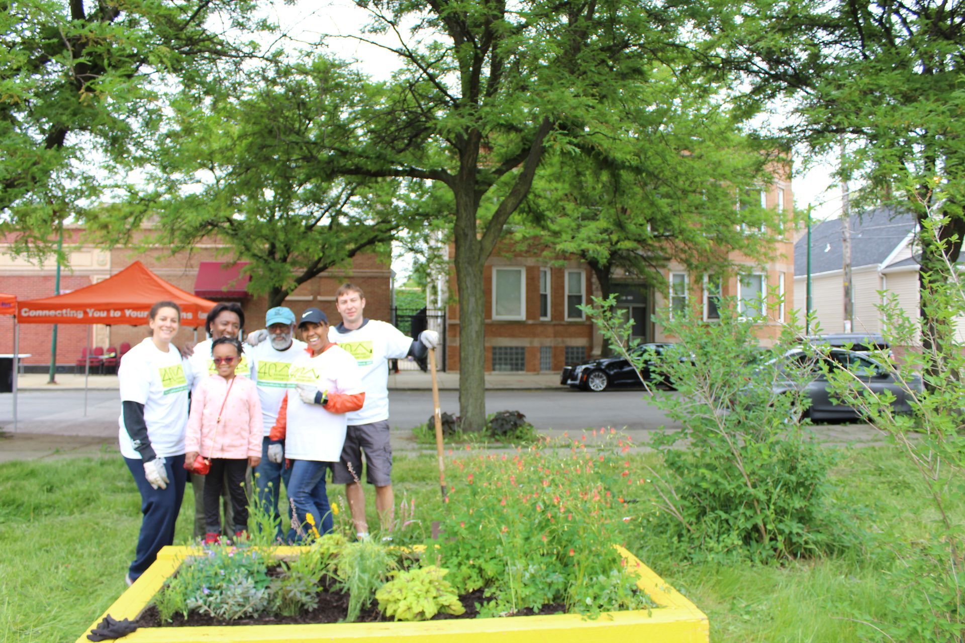 A woman is sitting at a bar holding two drinks.