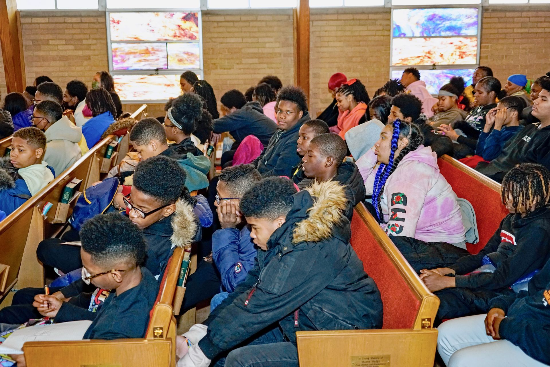 Youth sitting in assembly.