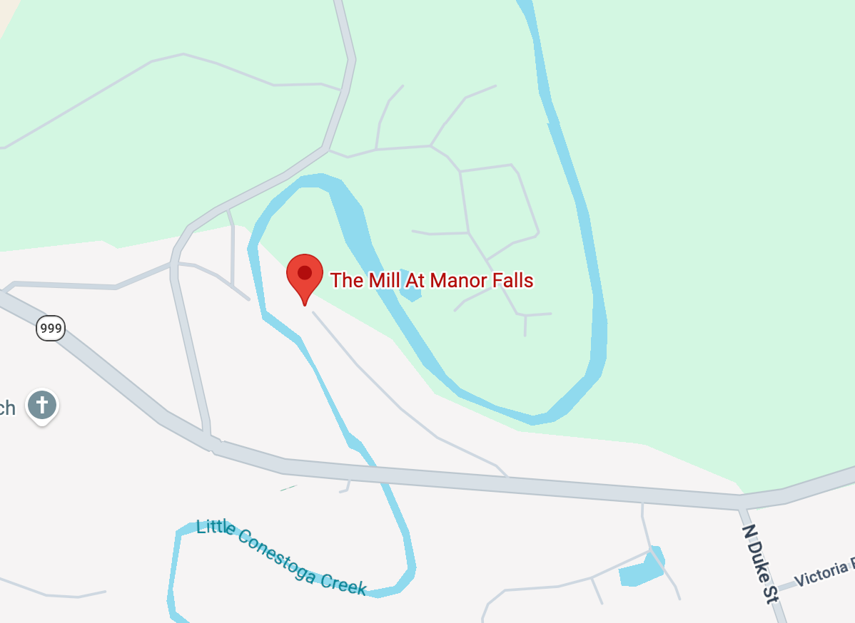 A digital map showing a red location pin for The Mill Creek Falls near a blue creek and roads.