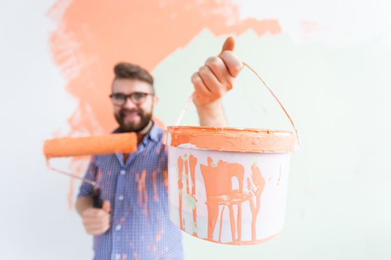 man holding the paint bucket