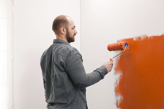 man using the paint roller