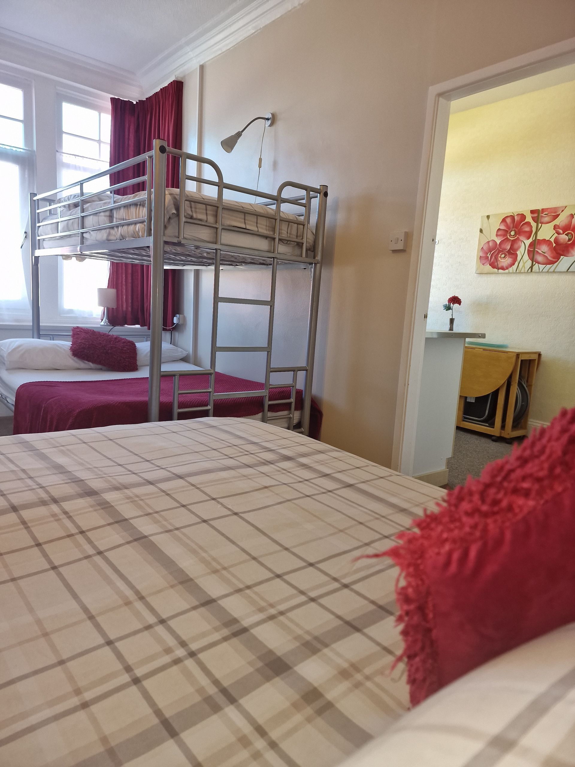 A bedroom with a bunk bed and two beds