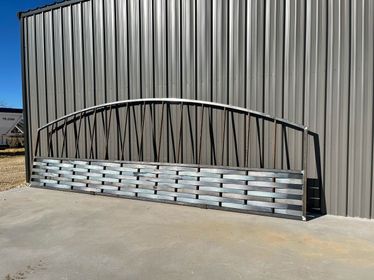 A metal bridge is sitting in front of a building.