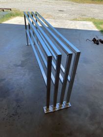 A metal railing is sitting on a concrete surface.