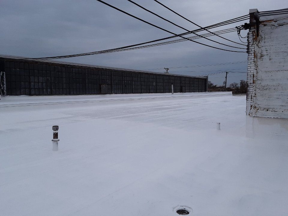 A large building with a lot of windows is covered in snow.