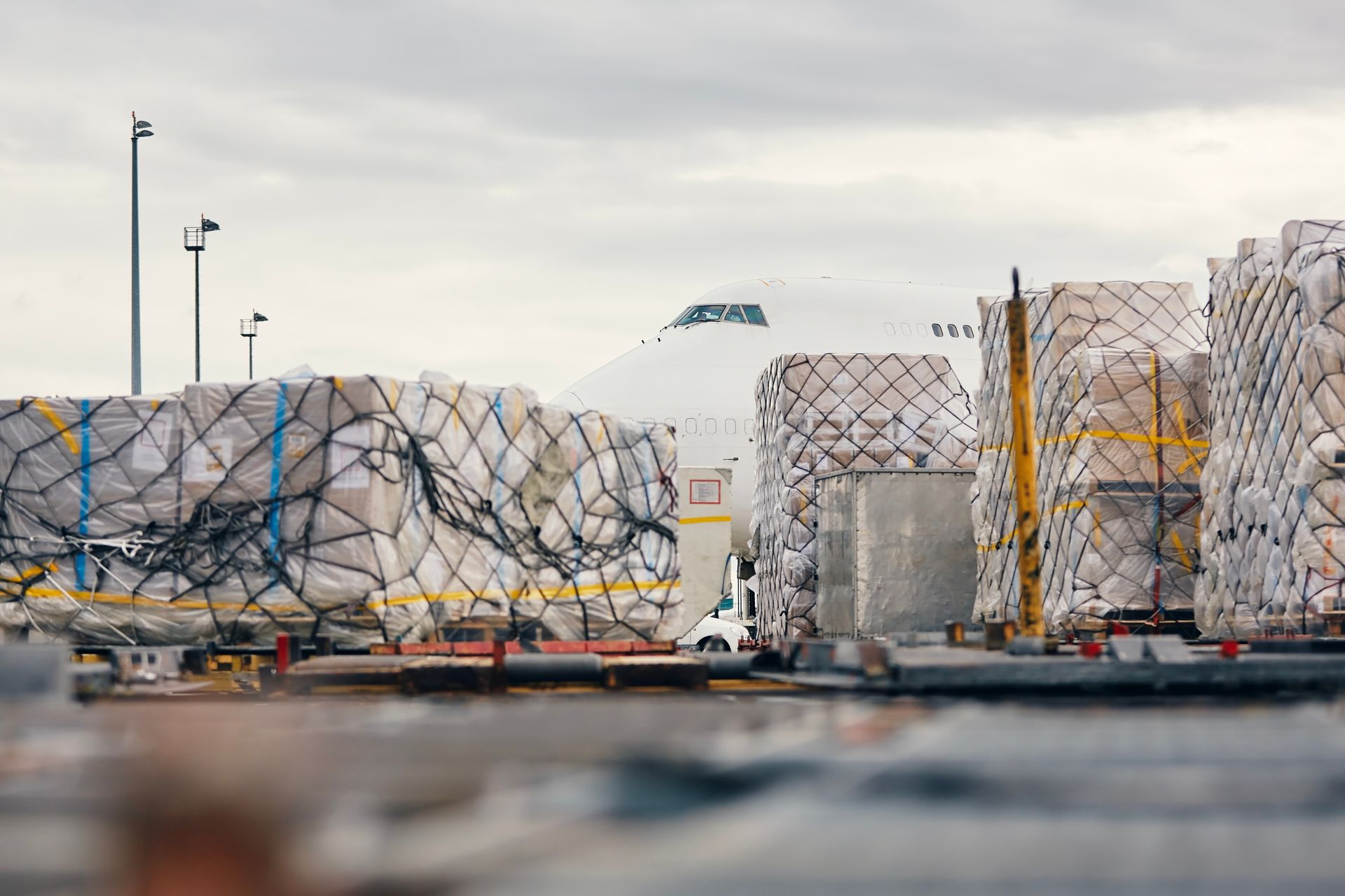 A lot of cargo is being loaded onto a plane at an airport.