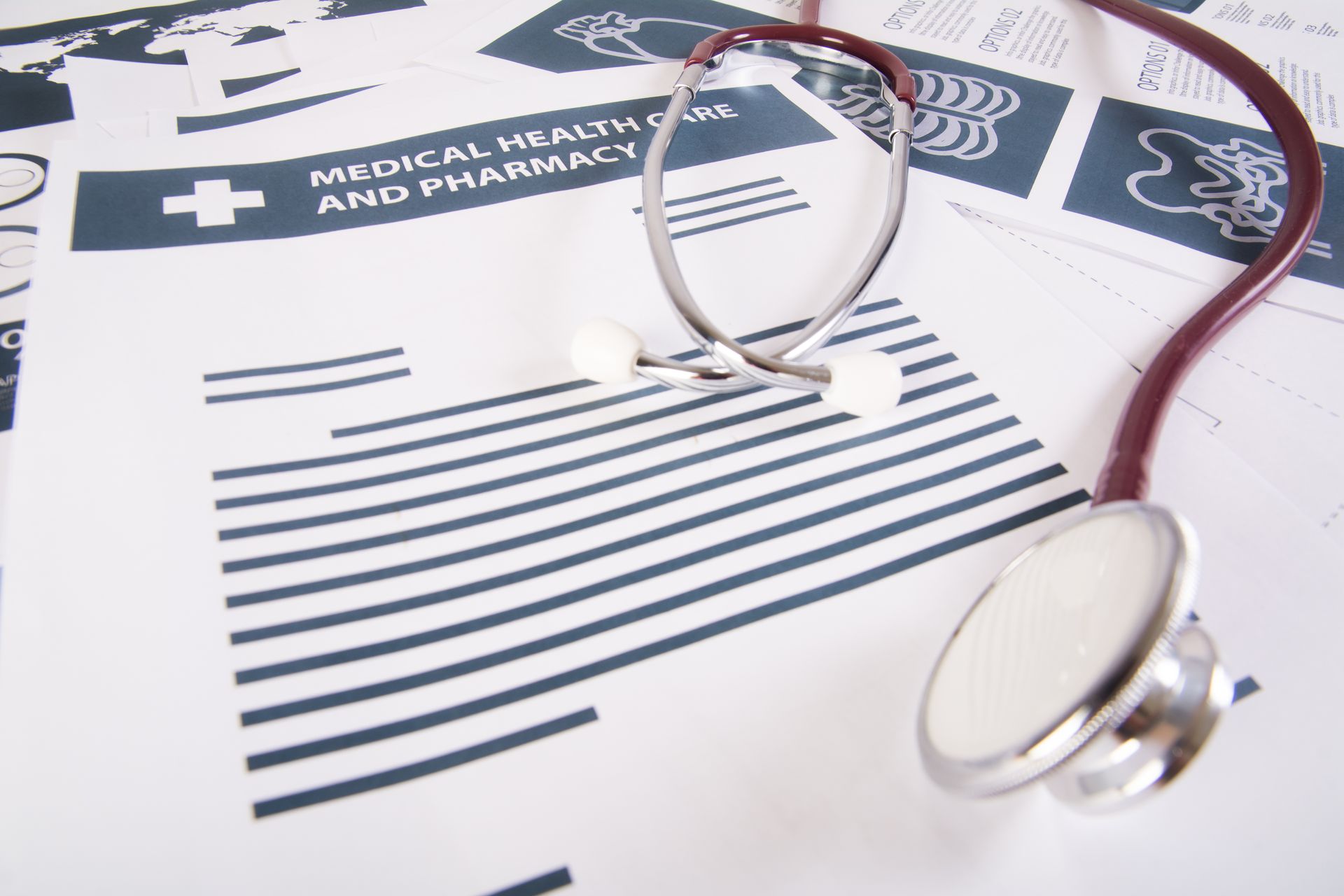 A stethoscope is laying on top of a medical health and pharmacy paper