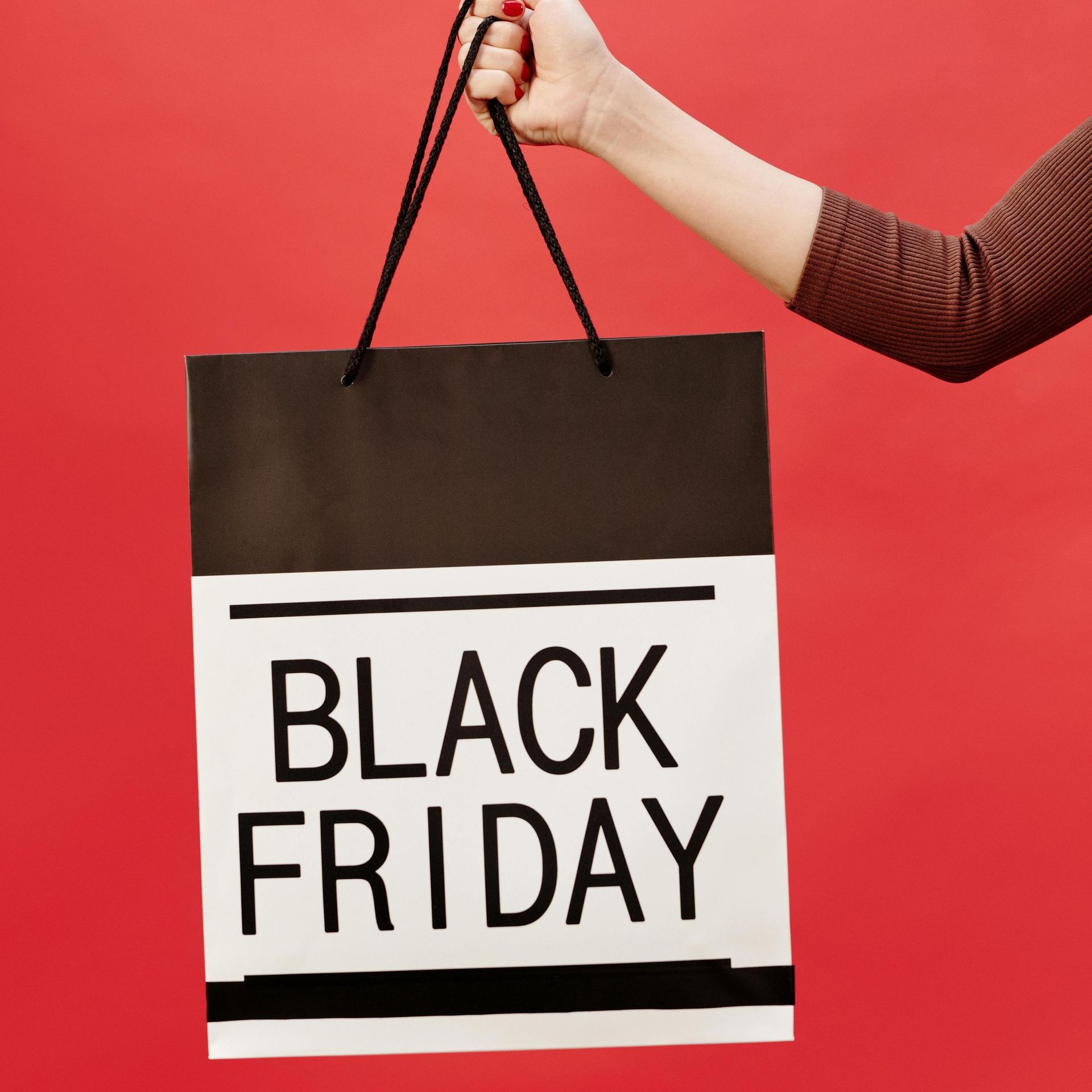 A person is holding a black friday shopping bag