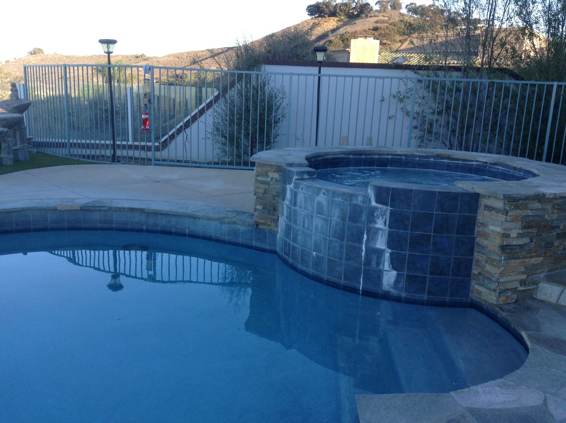 A large swimming pool with a waterfall in the middle