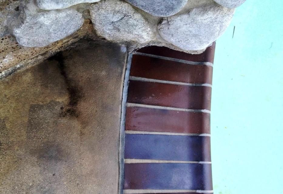 A close up of a guitar neck on a wall