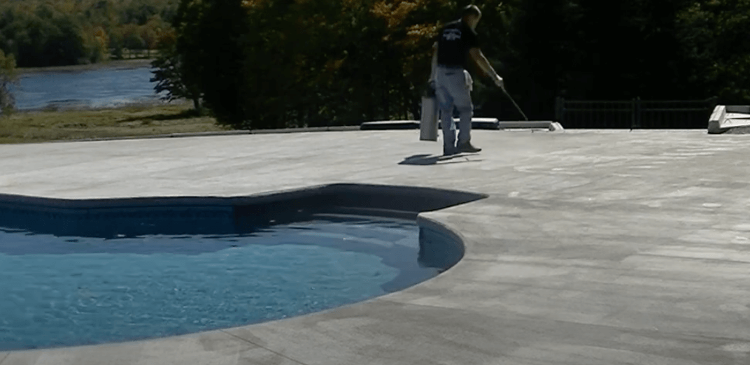 Pool deck contractors working on finishing touches of project in cypress TX