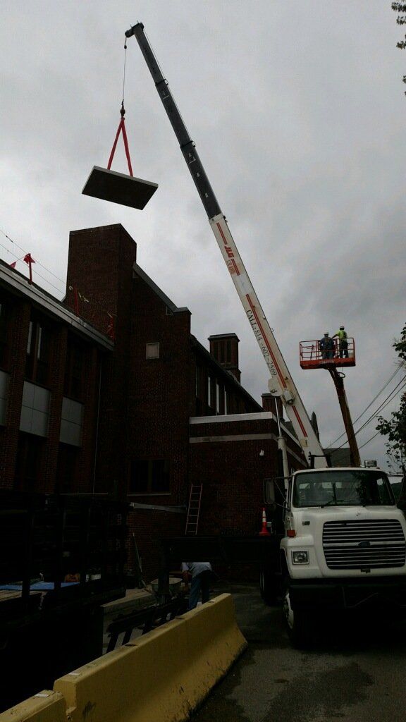 Crane Service Lifting Construction Materials onto Building