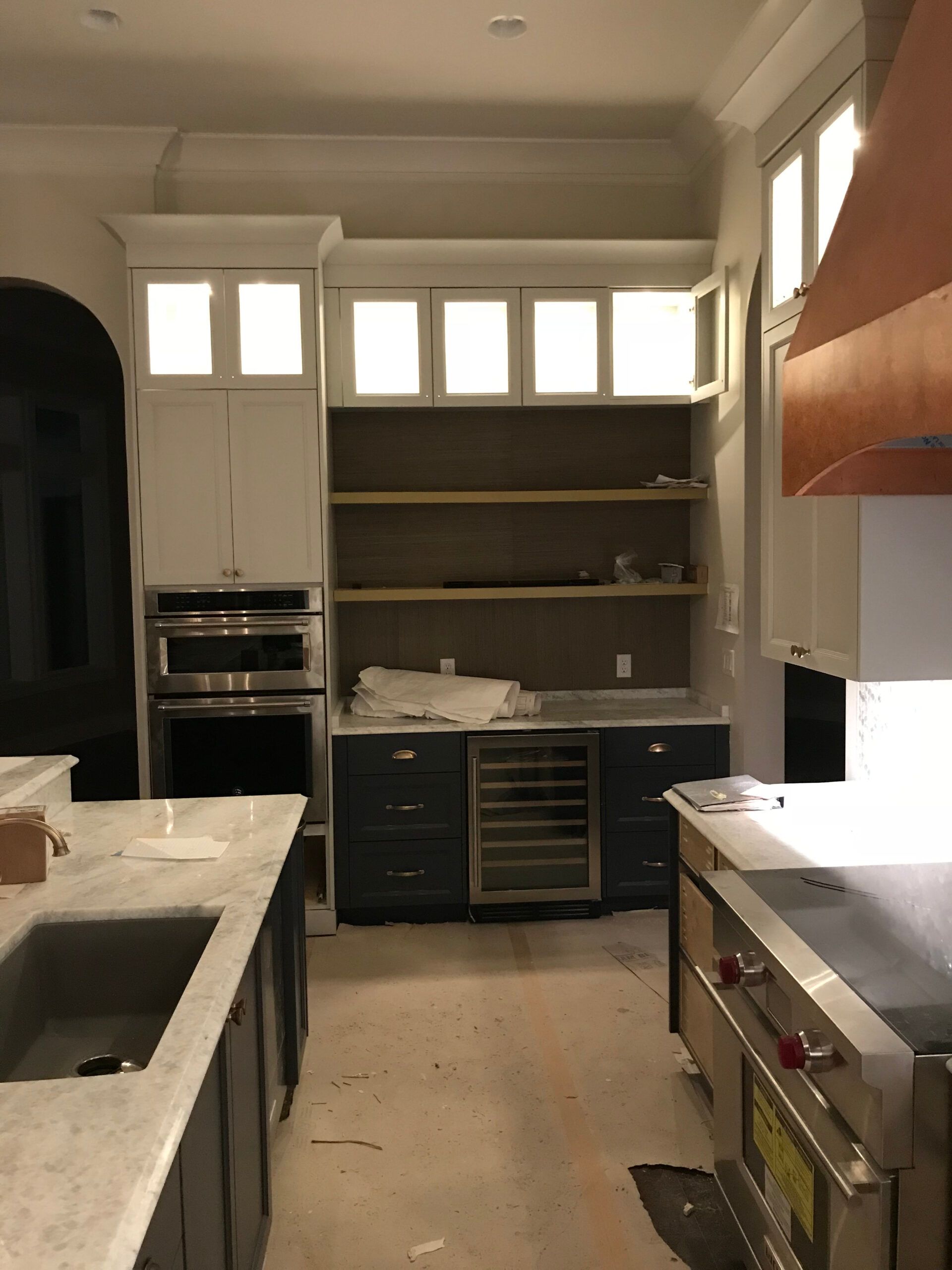 A kitchen with stainless steel appliances and white cabinets