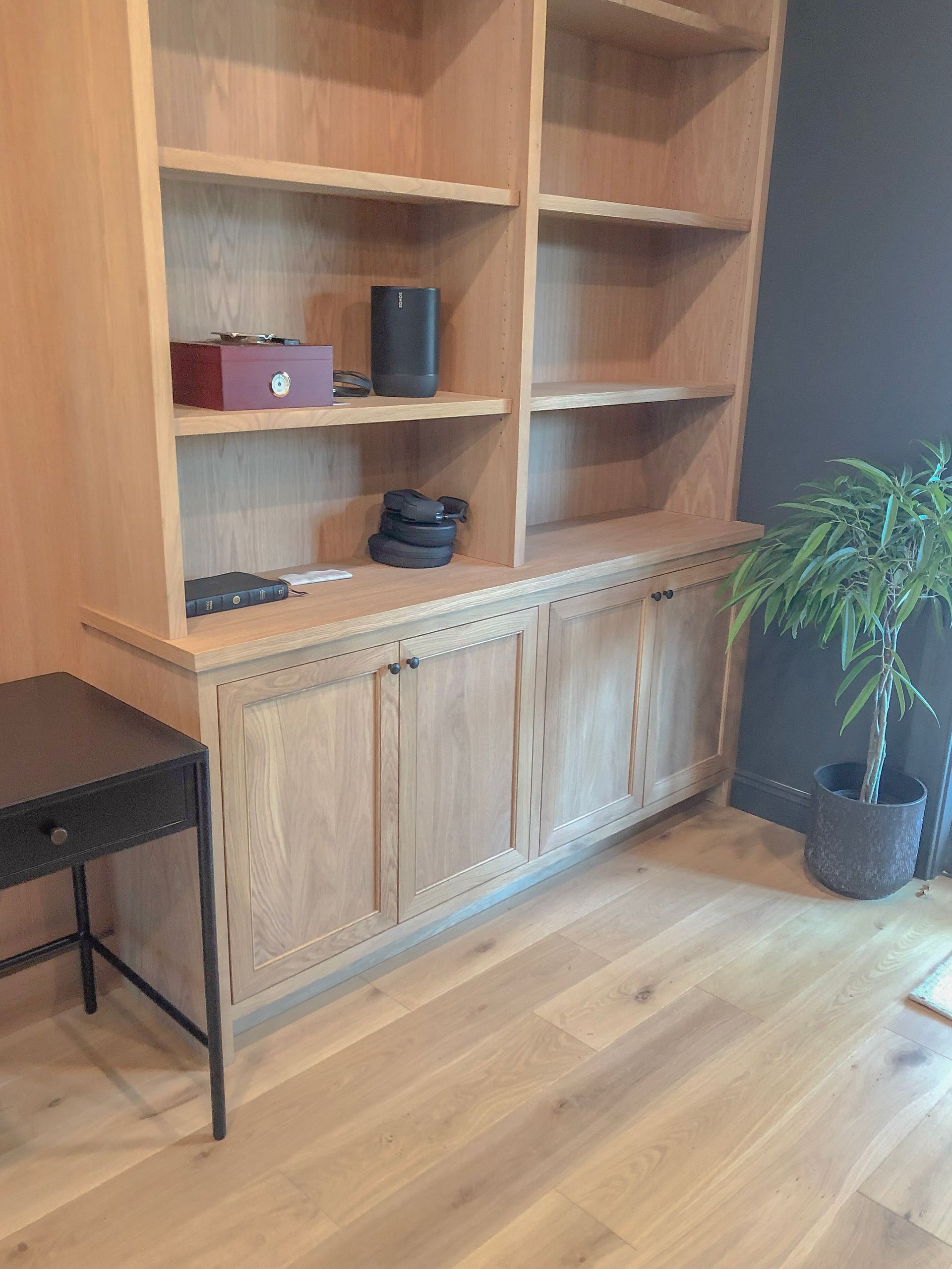A walk in closet with lots of shelves and drawers and a dresser.