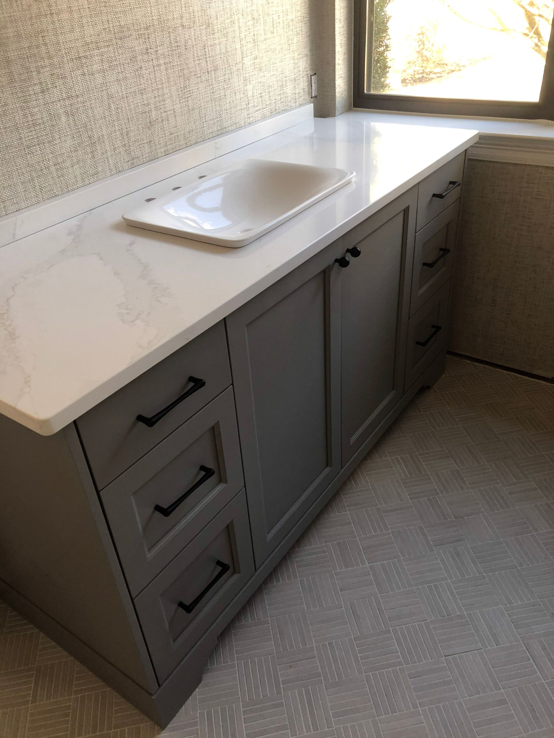 A kitchen with stainless steel appliances and white cabinets