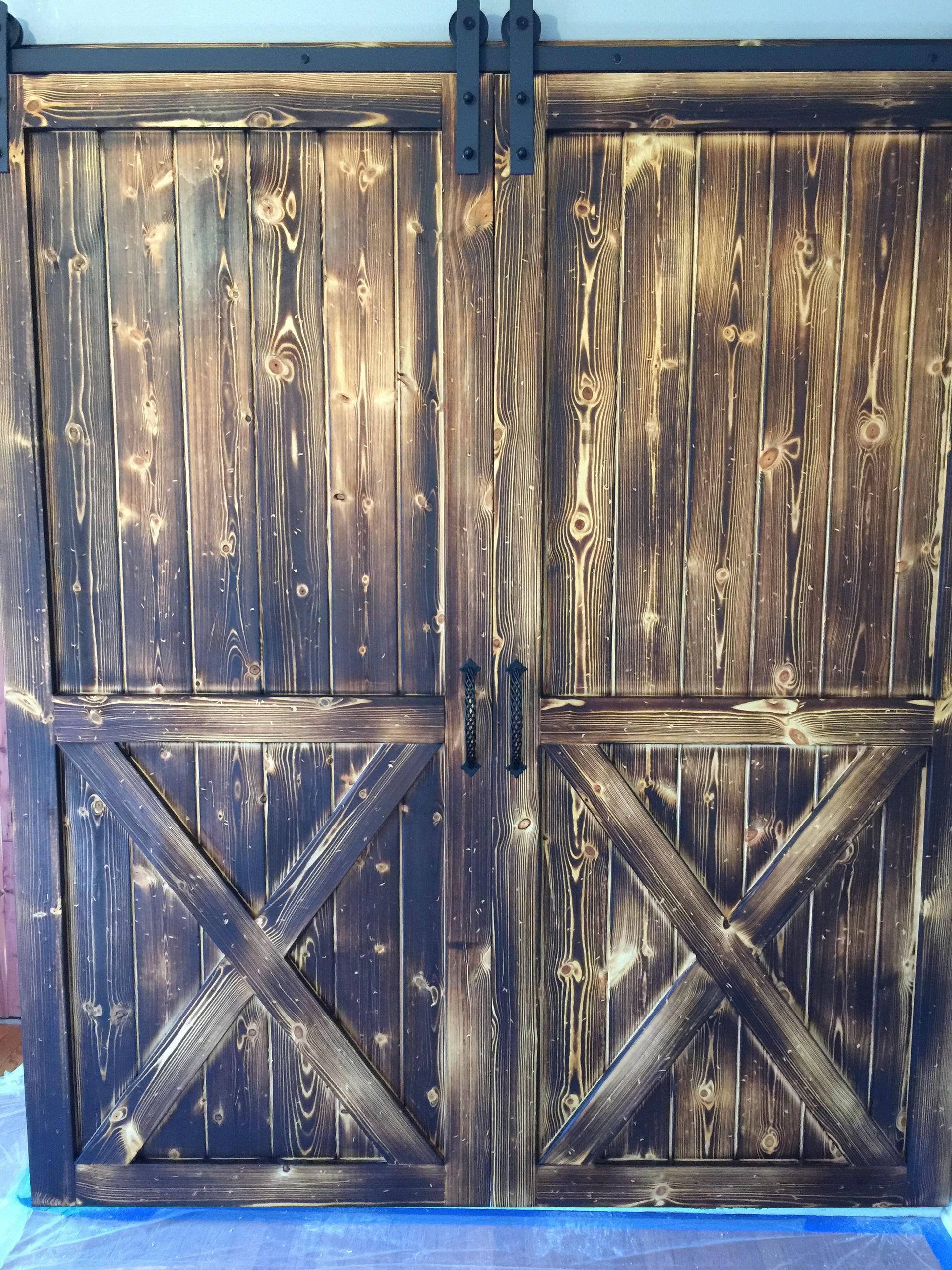 A door with a cross on it is in a hallway