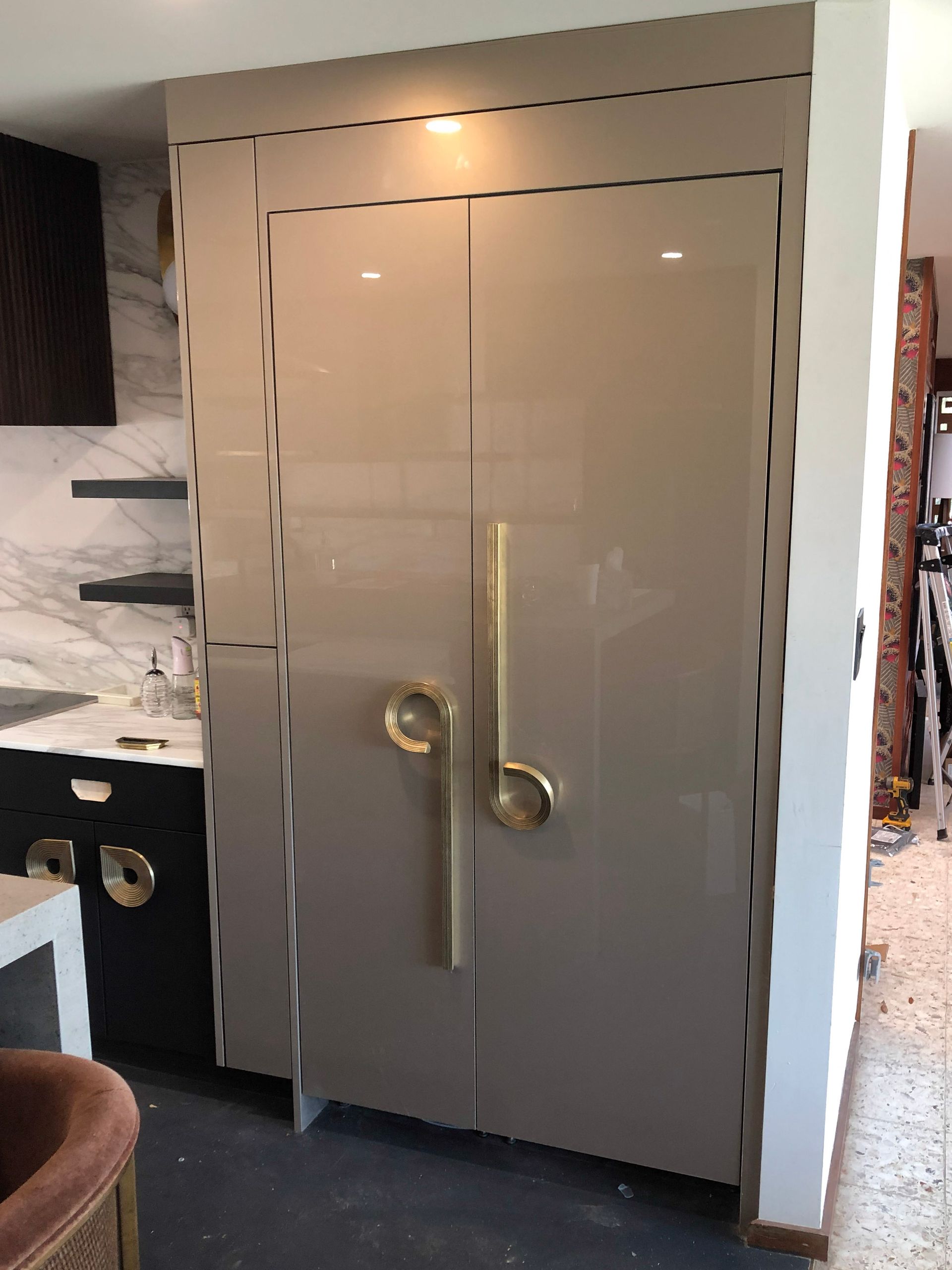 A bathroom vanity with a sink and drawers and a rug on the floor.