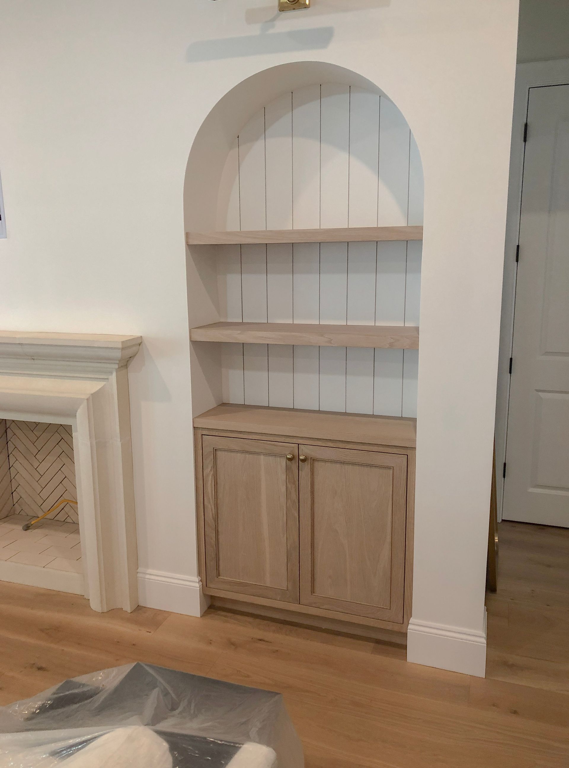A kitchen with a bar and a lot of tools on the floor.