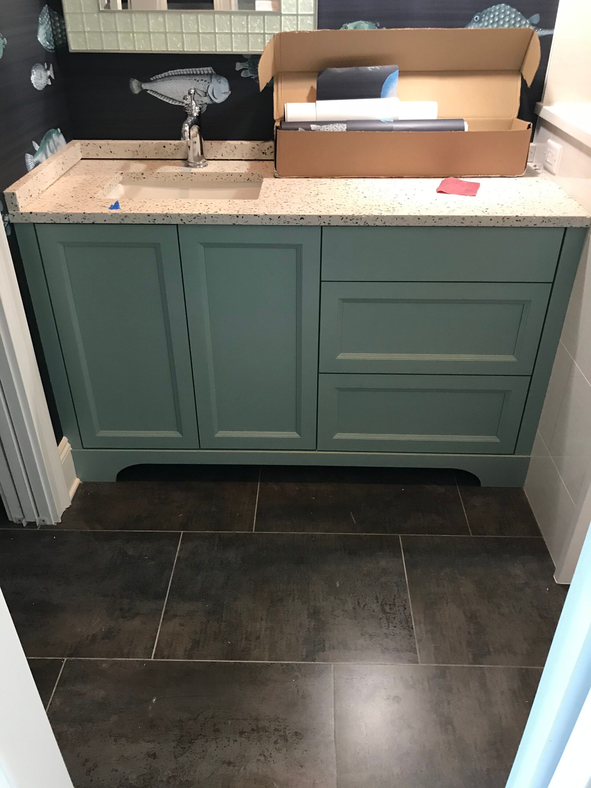 A bathroom with a sink and a box on top of it