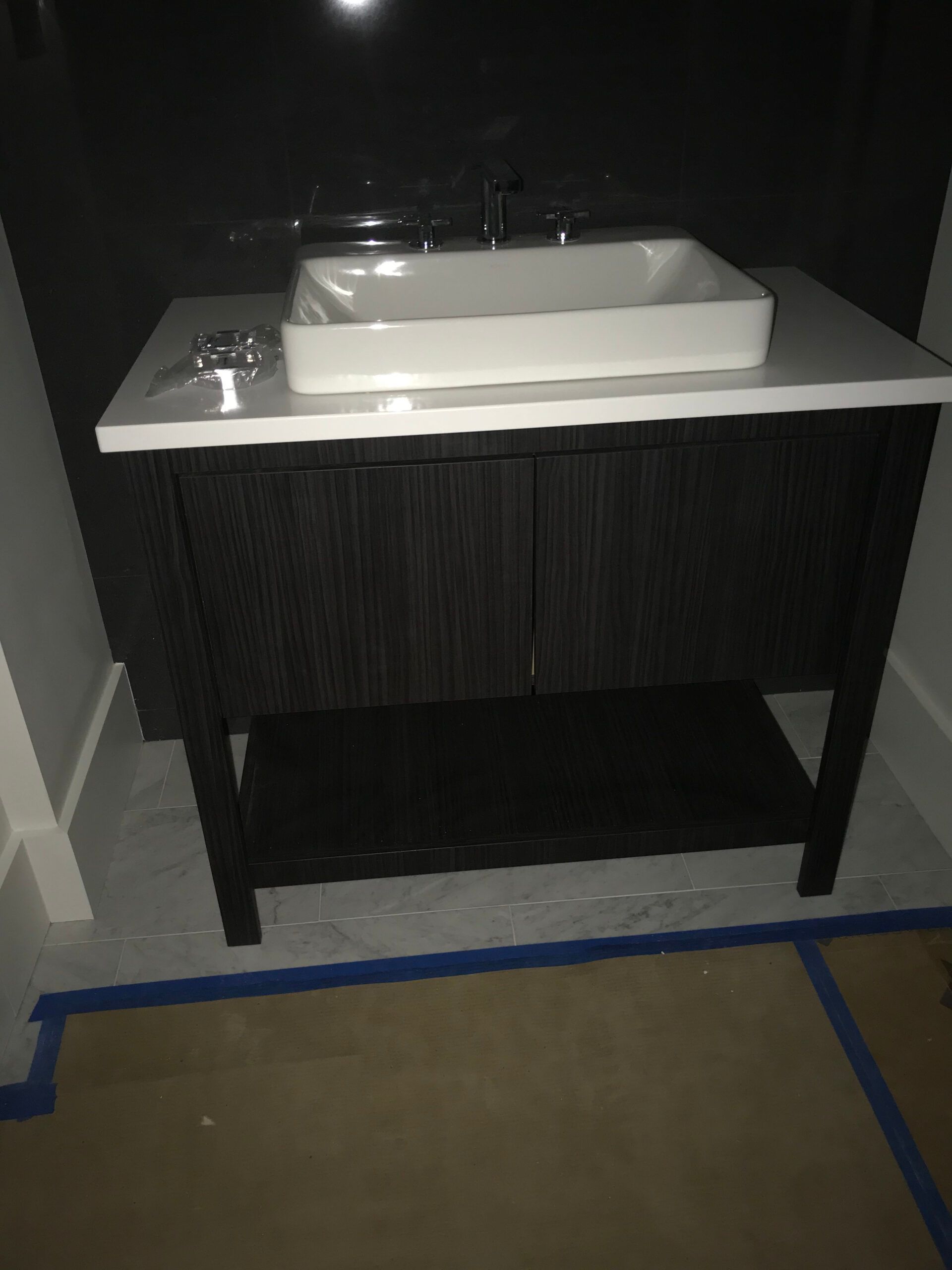A bathroom vanity with a sink on top of it