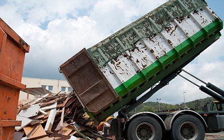 Roll-off Dumpster Rental — Dump Truck Unloading Wood Waste in New Braunfels, TX
