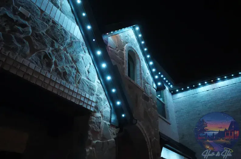Building exterior with blue lights along the roofline, against a dark sky.