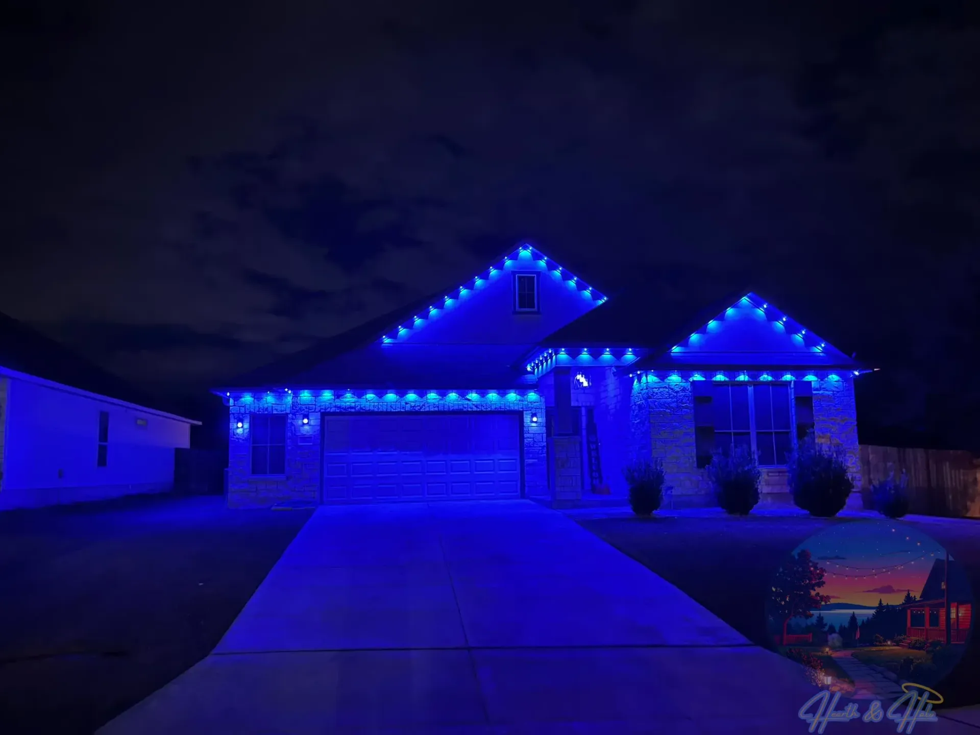 A house at night with blue Christmas lights lining the roof and windows.
