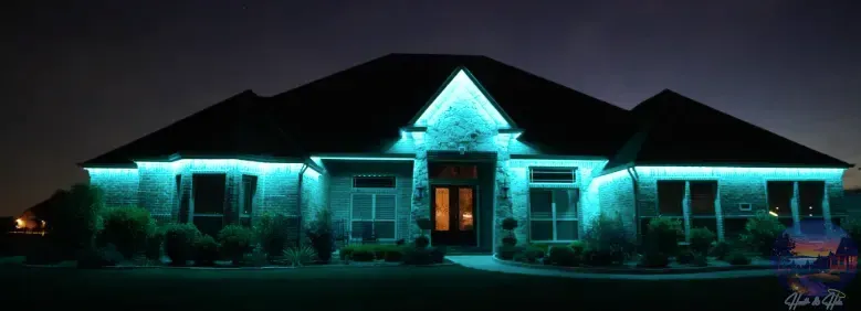 House at night with blue lights outlining the roof and windows.