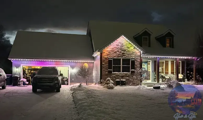 House with colorful lights and snow, a vehicle parked in the driveway at night.