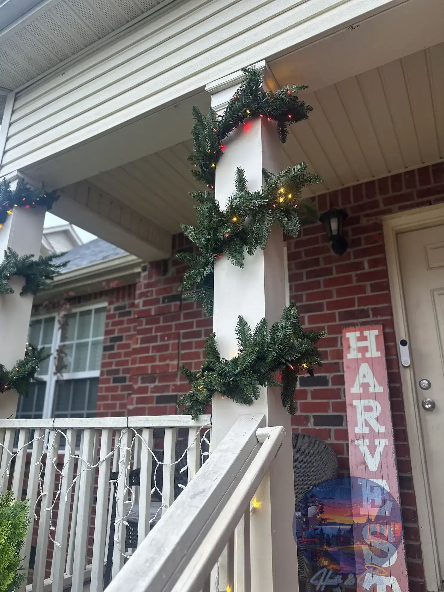 Porch decorated for with a garland wrapped around a porch column