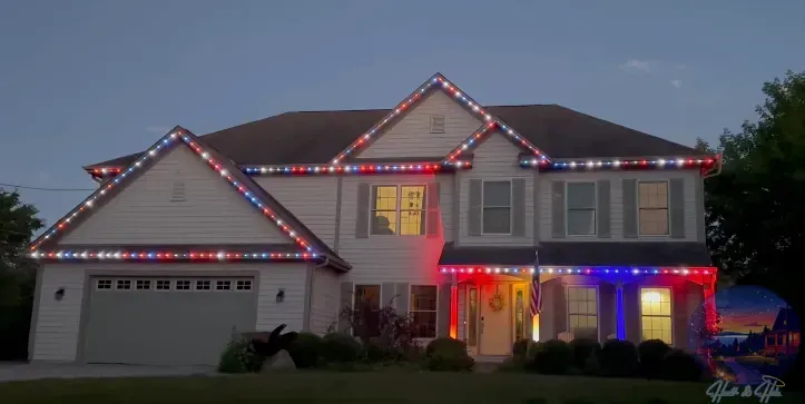 A house decorated with red, white, and blue lights, with the lights outlining the roof and porch.