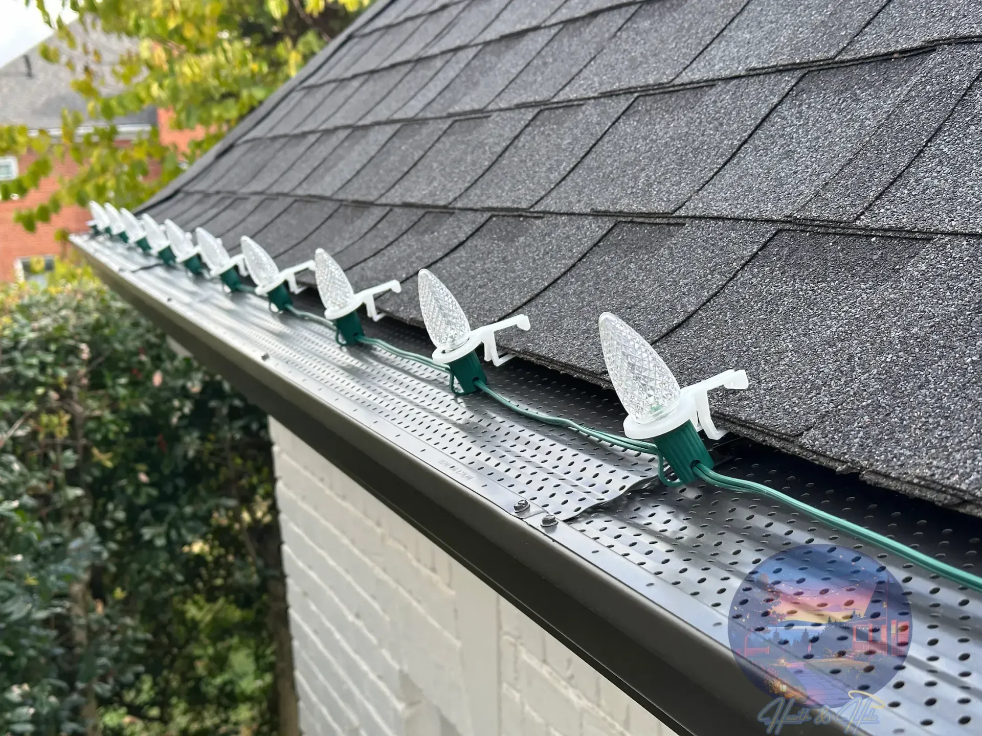 White two-story house with green lawn and fall foliage.