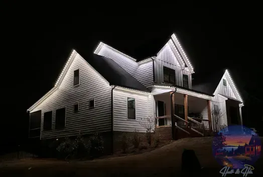A house decorated with red, white, and blue lights, with the lights outlining the roof and porch.