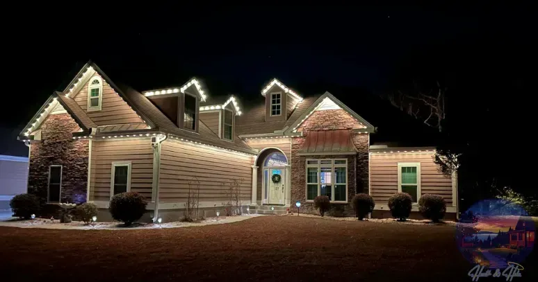 House at night, illuminated with white Christmas lights.