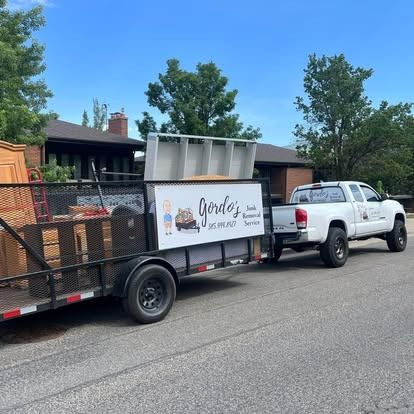 A truck and trailer are parked on the side of the road.