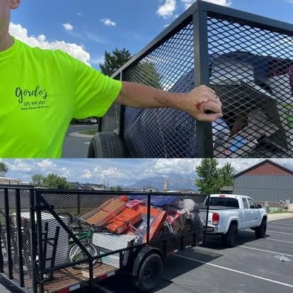 A man in a neon green shirt is standing next to a truck with a trailer full of trash.