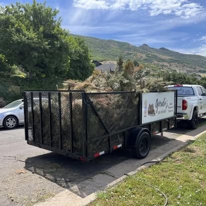 A truck and trailer are parked on the side of the road.