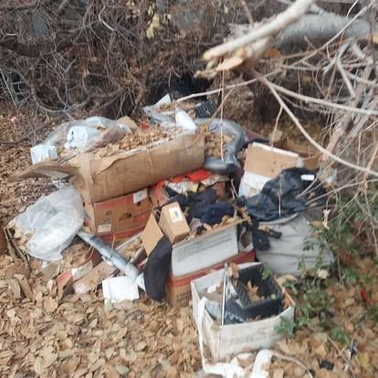 A pile of cardboard boxes and trash on the ground