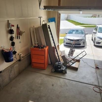 A car is parked in a garage with the door open.