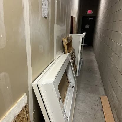 A long hallway with a lot of boxes on the floor.