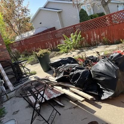 There is a lot of trash in the backyard of a house.
