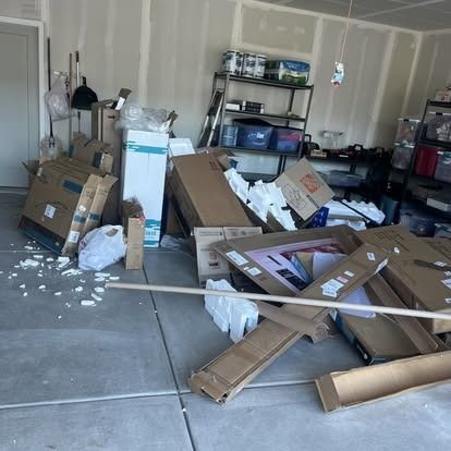 A garage filled with boxes and a wooden stick