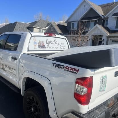 A white truck is parked in front of a house.