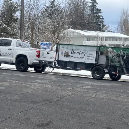 Two trucks are parked next to each other on the side of the road.
