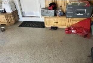 A room with a lot of furniture and boxes on the floor.