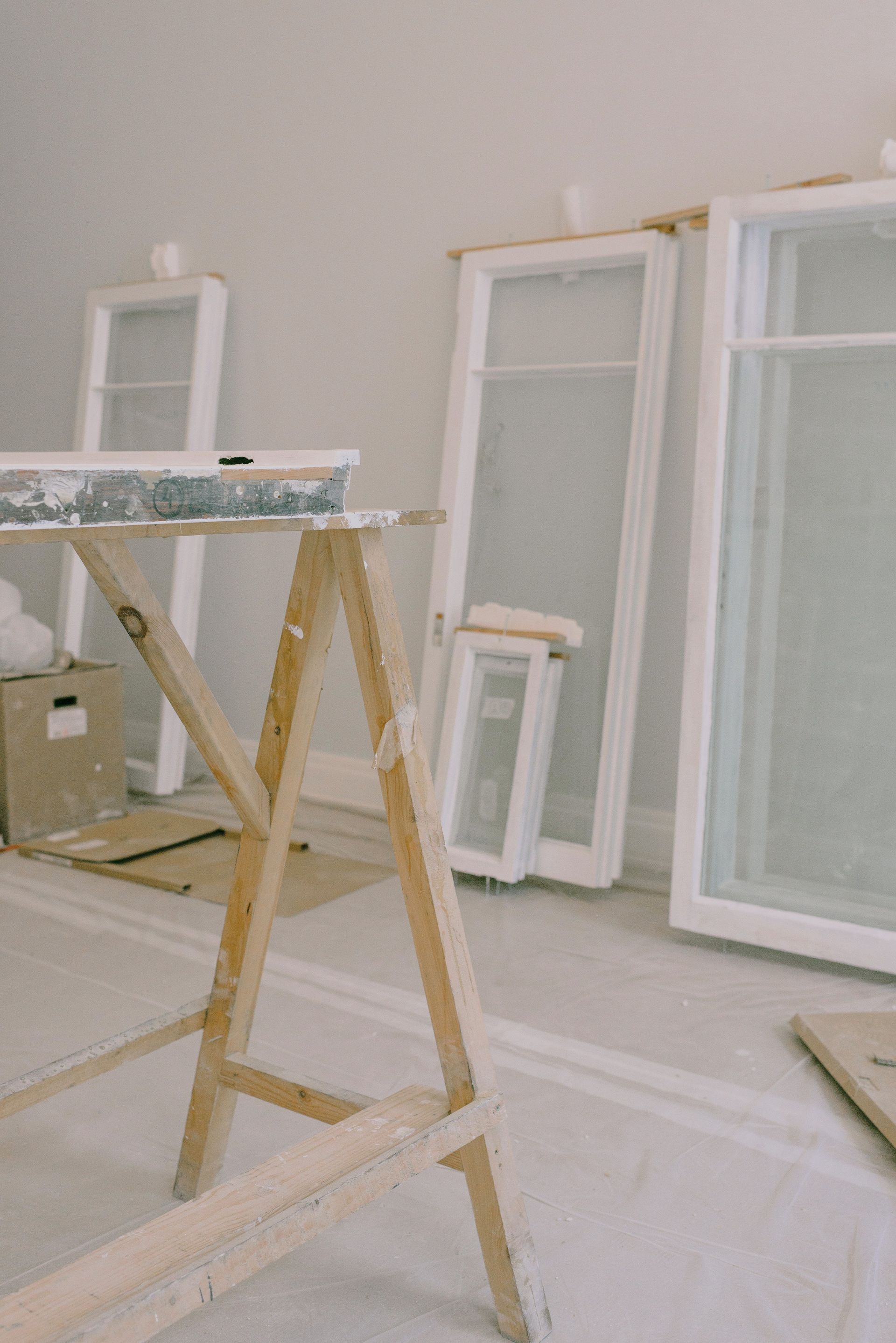 Room under renovation with tools and construction materials.