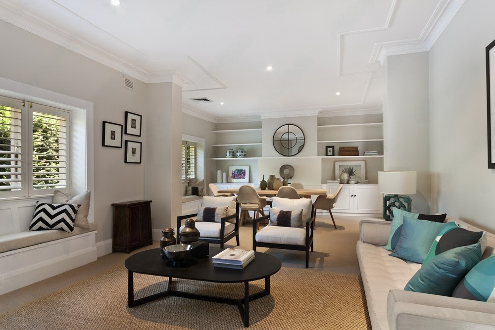 a living room with a couch , chairs , and a coffee table .